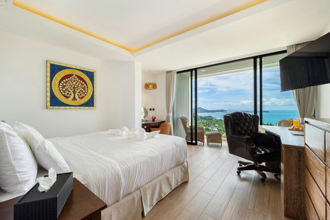 Bedroom with sea-view sliding doors, desk and private balcony access at Villa Yoco, Koh Samui