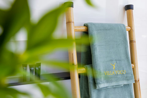 Bamboo towel rack with branded towels and natural light at Villa Yoco, Koh Samui