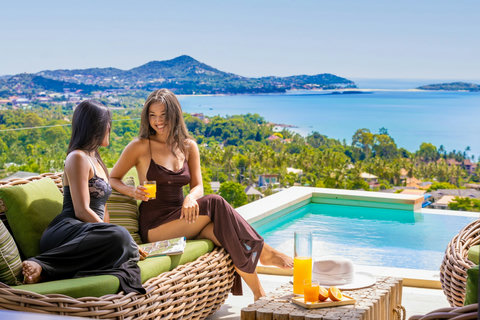 Guests socializing with drinks by the pool at Villa Yoco, Koh Samui
