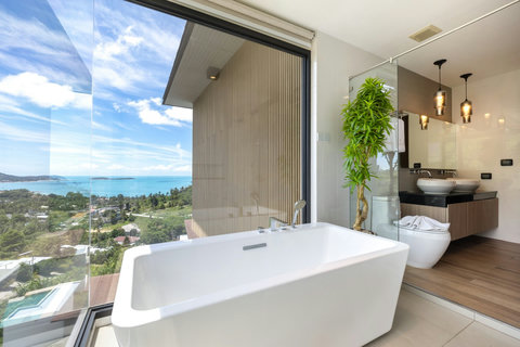 Bathroom with freestanding tub, greenery and panoramic sea views at Villa Yoco, Koh Samui