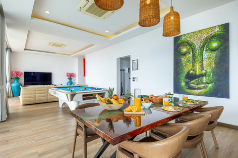 Open-plan dining and games area with pool table and feature mural at Villa Yoco, Koh Samui
