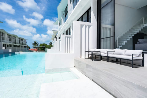 Outdoor balcony with glass railing at C'est la Vie, Replay Residence Koh Samui