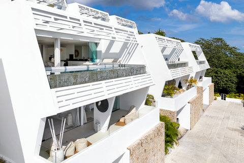 Hillside villa exterior with covered outdoor seating and ocean views in Koh Samui vacation rental