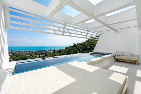Covered terrace with sliding glass doors and sweeping ocean view at Koh Samui luxury villa