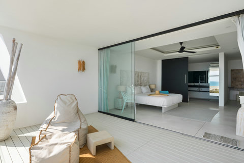 Elegant white bedroom with modern decor and high ceilings in Koh Samui luxury vacation rental