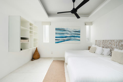 Bright guest bedroom with ocean artwork and sea views through double windows, Koh Samui villa