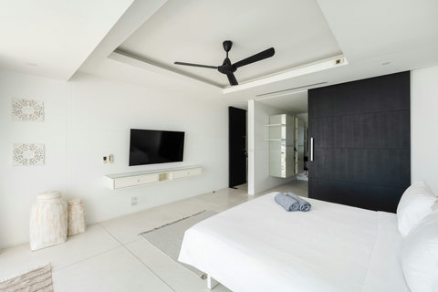 Luxurious canopy bedroom with ceiling fan and minimalist tropical design, Koh Samui Thailand