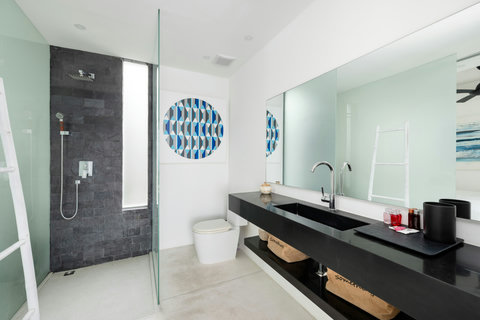 Sleek modern bathroom with double vanity and designer fixtures in luxury Koh Samui rental