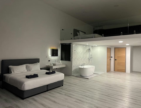 Cozy bedroom retreat with hotel-quality bedding and ambient lighting in Koh Samui villa