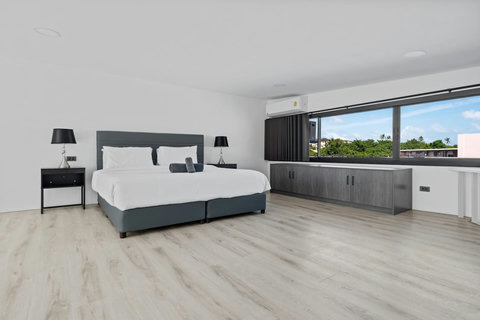 Stylish guest bedroom with upholstered headboard and sea-inspired decor at C'est La Vie villa