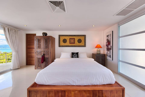 Bedroom with teak wood furniture and sea view windows Samui villa