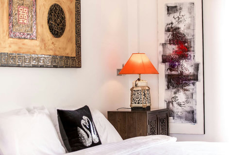 Elegant master bedroom with Asian-inspired artwork Thongsong Bay villa