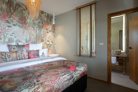 Artistic bedroom with vibrant floral decor at C Villa 8-bedroom luxury rental in Koh Samui
