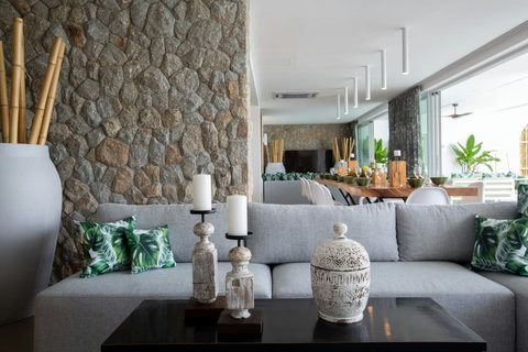 Contemporary living room with stone accent wall at C Villa luxury art retreat, Koh Samui Thailand