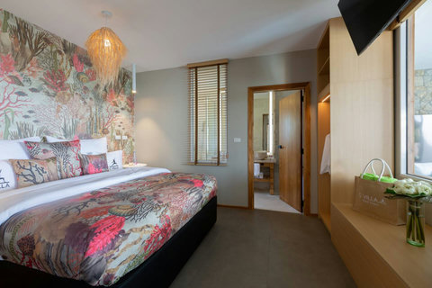 Vibrant tropical floral bedroom with red accents at C Villa 8BR luxury Koh Samui rental
