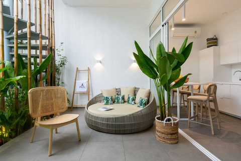 Designer outdoor lounge with rattan furniture and tropical plants at C Villa, Koh Samui Thailand