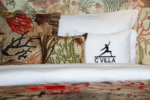 C Villa branded tropical decor and designer cushion at luxury art villa in Plai Laem, Thailand