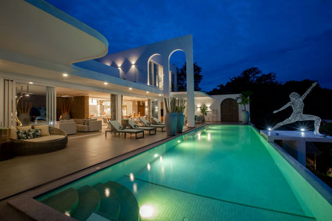 C Villa nighttime exterior with illuminated pool and white architecture in Koh Samui, Thailand