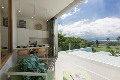 Modern architectural corridor with ambient lighting at C Villa art villa, Koh Samui