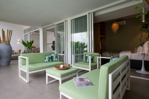 Outdoor green sitting area with garden views at C Villa 8BR Plai Laem vacation home