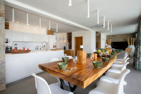 Rustic wooden dining table with tropical greenery at C Villa 8BR vacation home, Koh Samui Thailand
