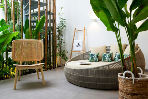 Stylish rattan lounge chair in tropical outdoor area at C Villa luxury retreat, Koh Samui