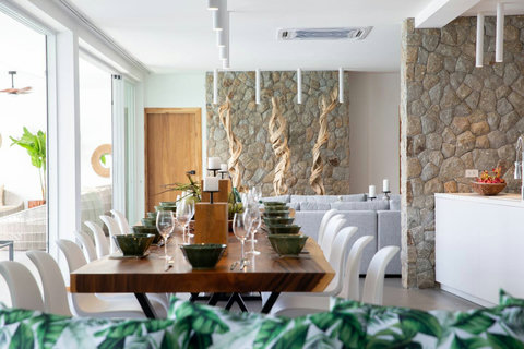 Modern dining room with long table for 8 guests at C Villa luxury Koh Samui retreat