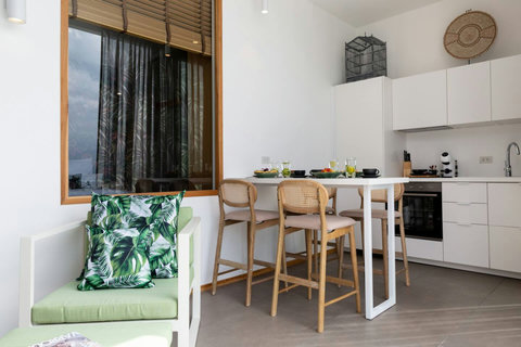 Tropical banana leaf dining area with modern furniture at C Villa, Plai Laem Koh Samui