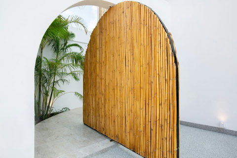 Artisan arched doorway with tropical greenery at C Villa designer retreat, Koh Samui