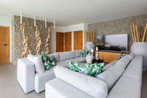 Spacious living room with tropical plants and modern sofas at C Villa, Koh Samui Thailand