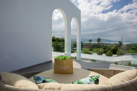 Covered outdoor terrace with ocean views and rattan seating at C Villa, Koh Samui Thailand