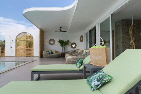 Outdoor lounge with ocean views and tropical garden at C Villa 8BR Plai Laem retreat