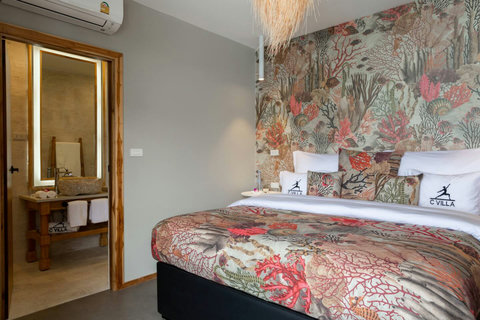 Tropical green bedroom suite with designer decor at C Villa art villa, Plai Laem Thailand