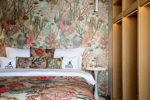 Tropical botanical bedroom with warm wood accents at C Villa 8-bedroom retreat, Koh Samui