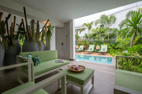 Tropical garden pathway with white architecture at C Villa art retreat in Plai Laem, Thailand