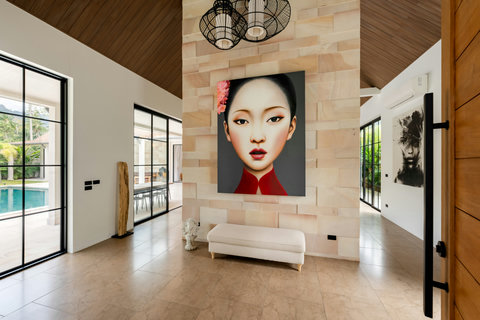 Art meets entry. A striking portrait installation welcomes you, while windows frame the pool beyond. Pure creative comfort.