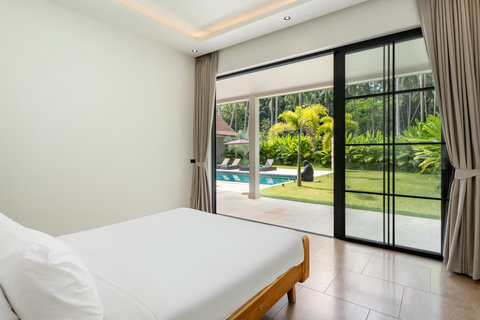 Drift to sleep gazing at palms and pool. Floor-to-ceiling glass connects your room to the lush tropical landscape beyond.