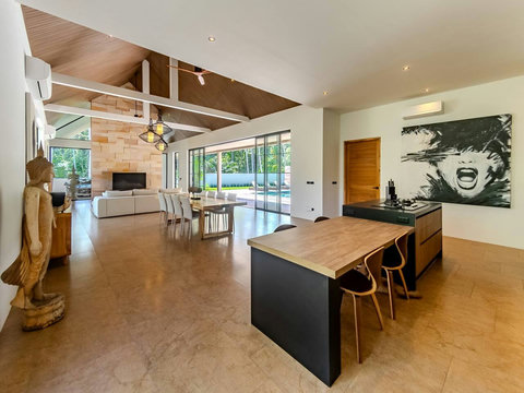 Gather in this soaring space where wood meets light, and every angle frames a view. The villa feels endless.