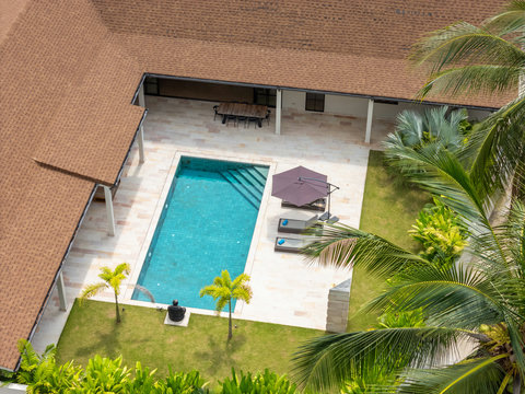 Pure blue relaxation. Loungers await poolside while the covered terrace offers shade and the villa stays just steps away.