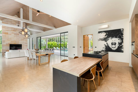 Flow freely through this heart of the home. Cook, dine, relax, and gaze at your pool all in one stunning open space.