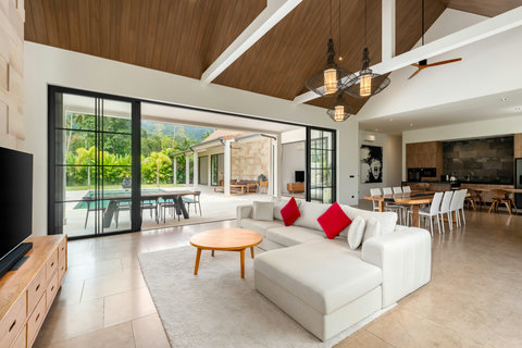 Relax in this light-filled living space where soaring wood ceilings meet floor-to-ceiling glass. The pool and garden are just a step away.
