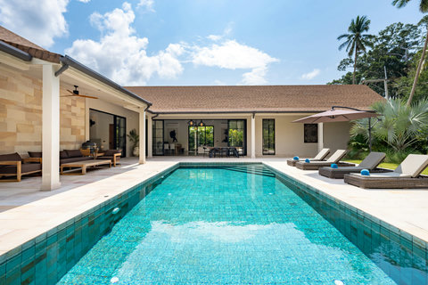 Float on a lounger with views across green hills, the tropical breeze cooling you as palms frame the horizon.