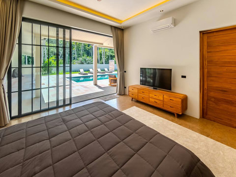 Step directly onto the pool deck from your bed through glass sliding doors. Morning light floods this room as you enjoy views of the garden and water
