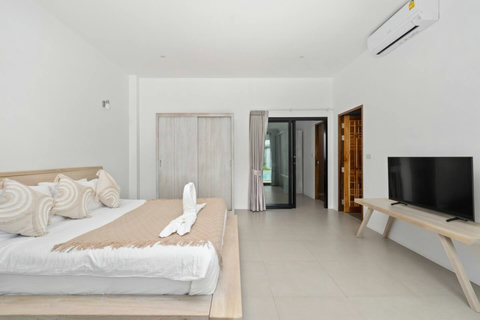 Serene bedroom with king-size bed and tropical garden views