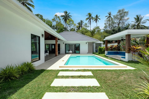 Sparkling private pool surrounded by swaying palm trees