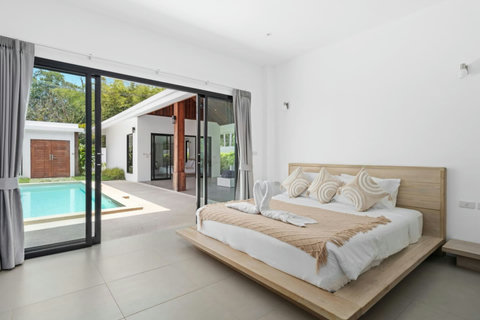 Bright bedroom with private pool views and natural light