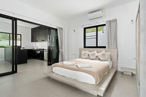 Elegant bedroom with pool views and stylish contemporary design
