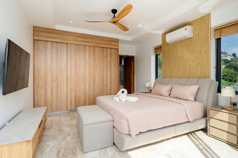 Spacious bedroom with ceiling fan and warm decor at Villa Gala 4BR, Koh Samui Thailand