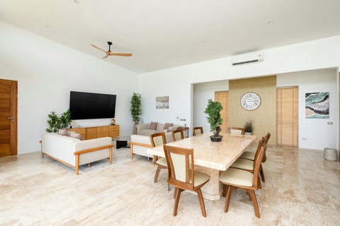 Spacious open-plan living area with modern design and ocean breezes at Villa Gala, Koh Samui