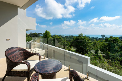 Hillside terrace with ocean views and outdoor seating at luxury Koh Samui rental